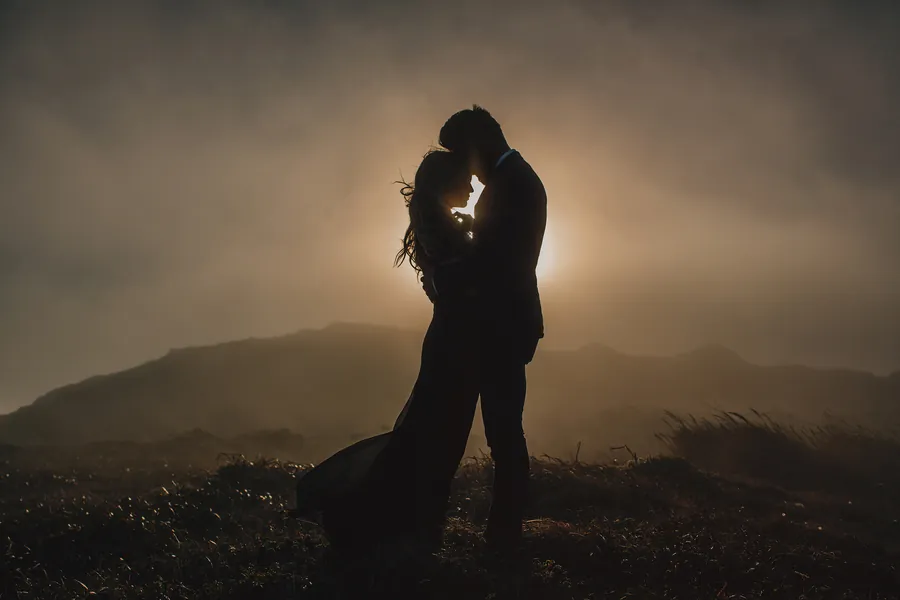 Silhouette d'un couple dans un contre-jour doré et vaporeux